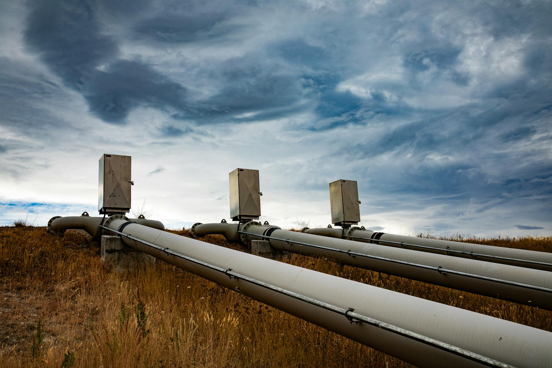 industrial pipe system under dramatic sky